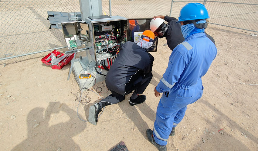 on-site support technicians installing and configuring warning system equipment